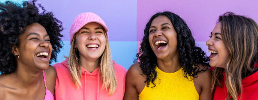 group of diverse women on bright wall laughing