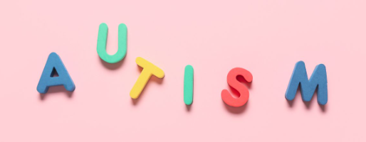 Graphic with pink background and colorful letters spelling out "AUTISM"