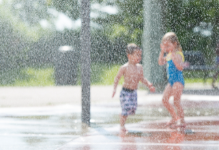 kids playing in sprinkler